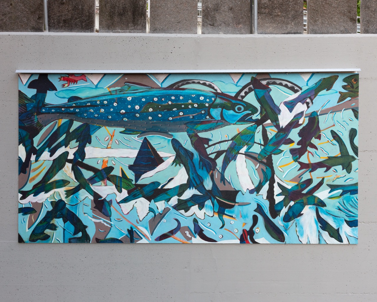 Painting on fiber cement of large fish with smaller fishes all around