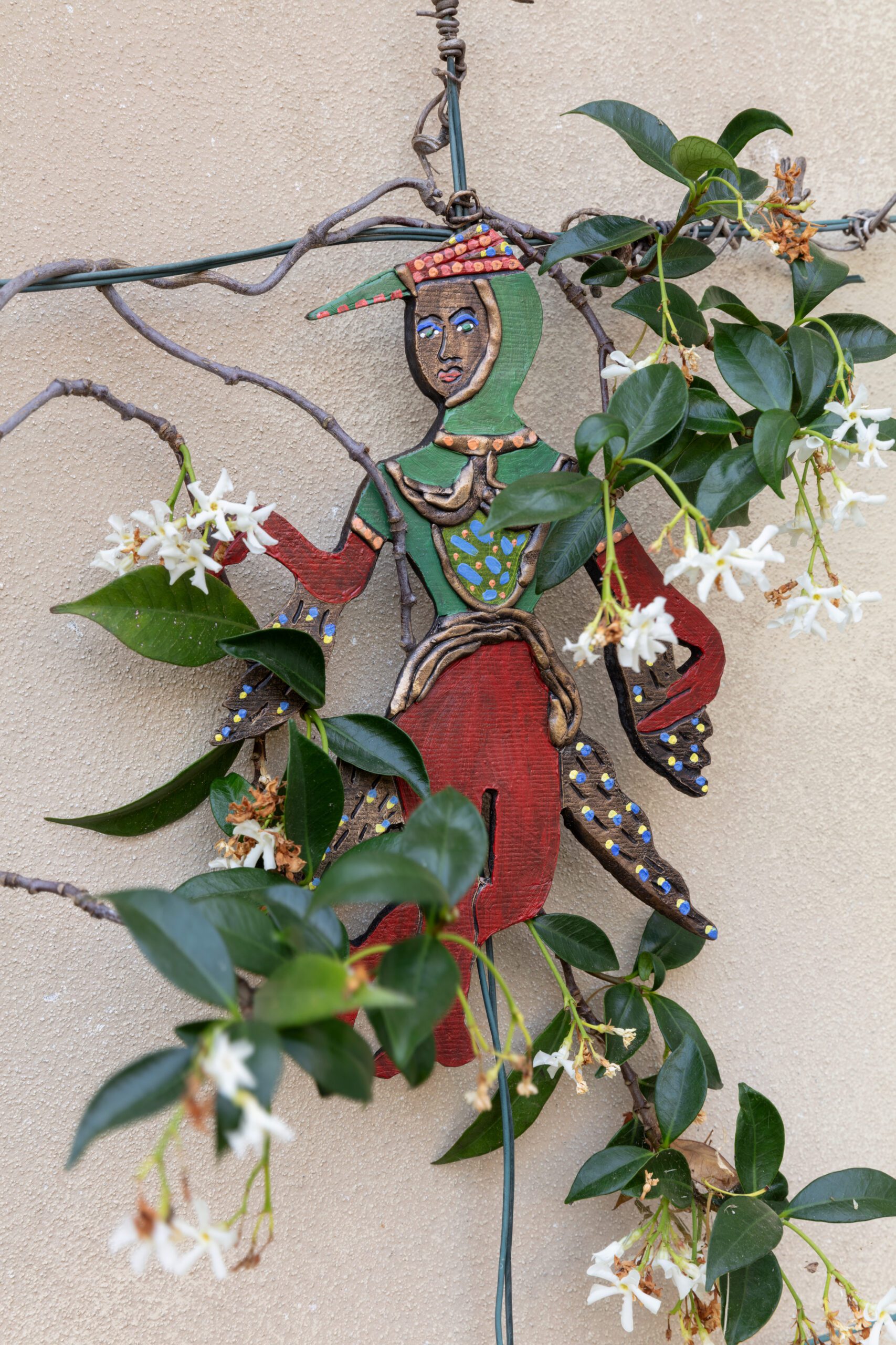 Oil on bronze figurine installed with jasmine climber plant