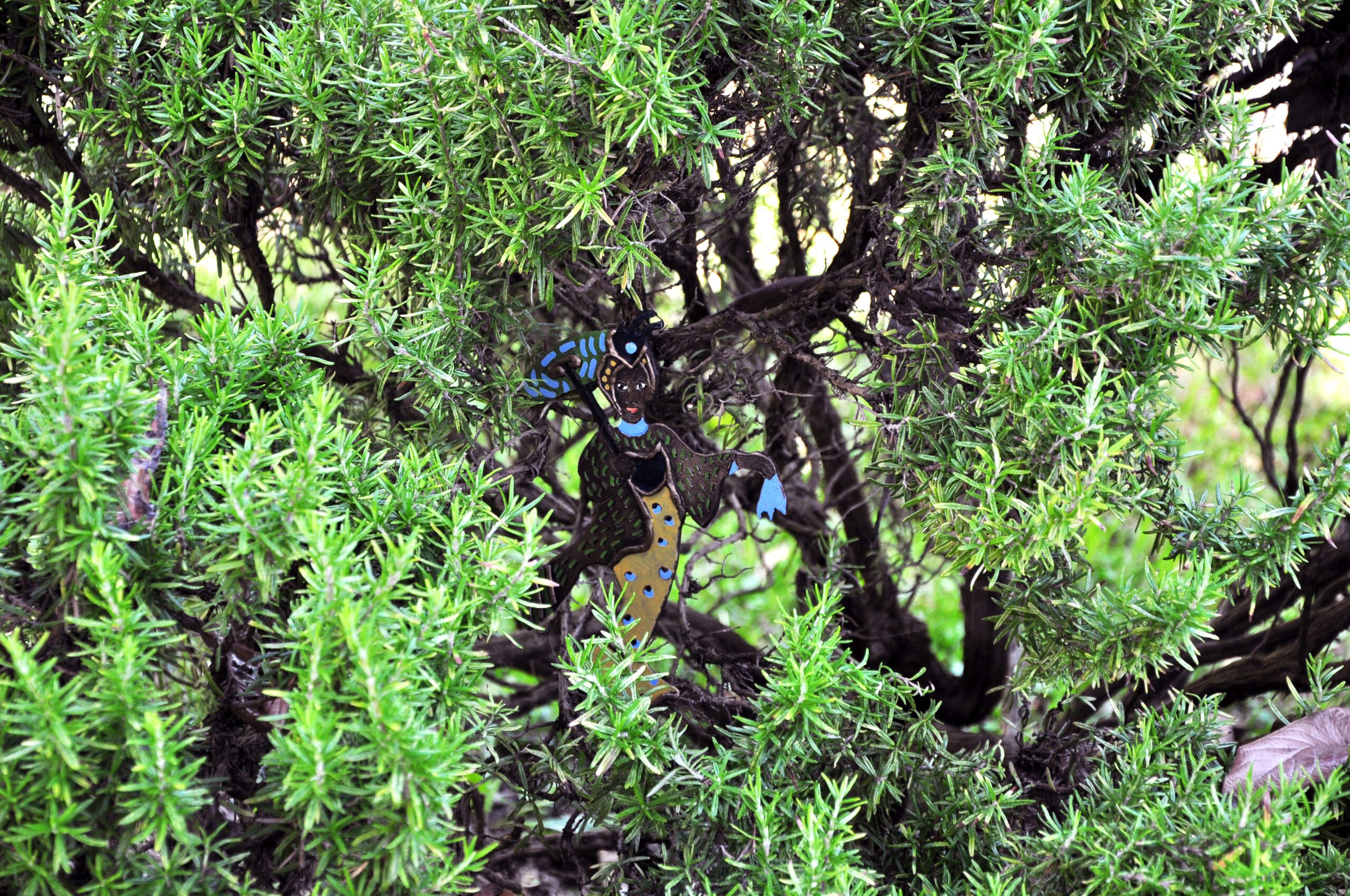 oil on bronze sculpture photographed inside rosemary bush