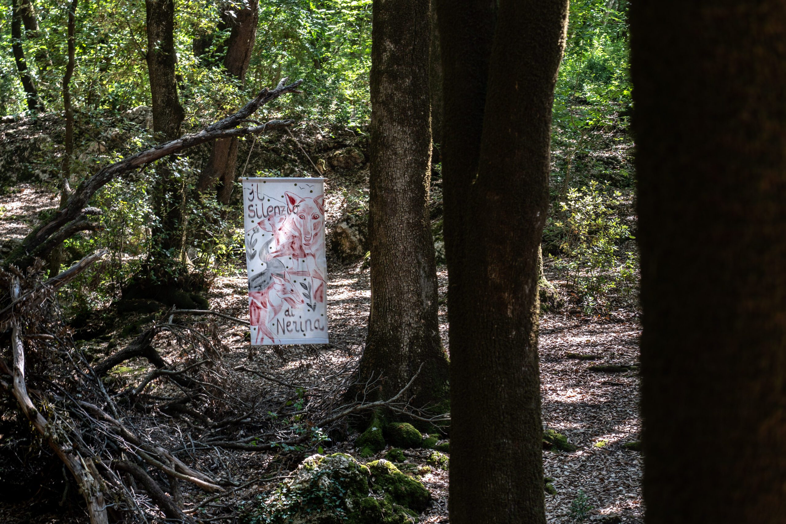 Acrylic on linen flag hoisted in woodland area