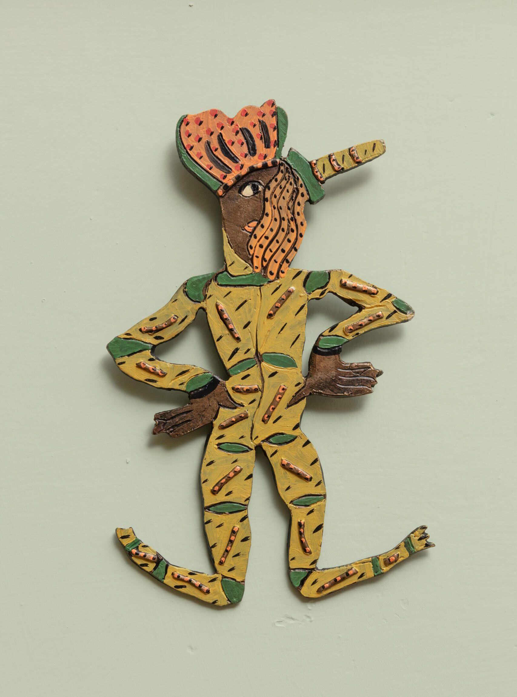 Oil on bronze figurine on light pea green background